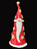 Red gnome figurine with a white beard and star decorations on a dark surface.