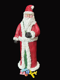 Santa Claus figurine on a black surface with a blurred background